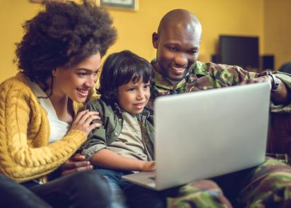 Military family looking at laptop computer