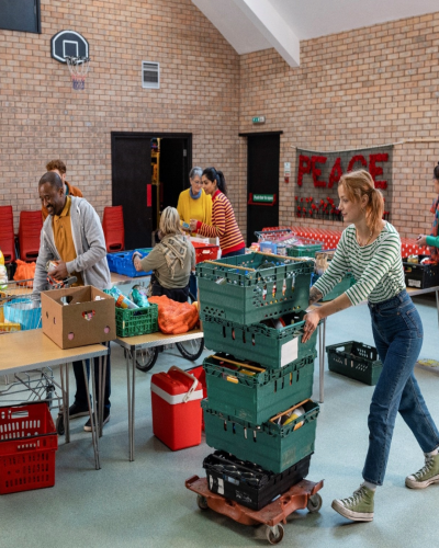 Volunteers work in a food donation center to organize donations. 