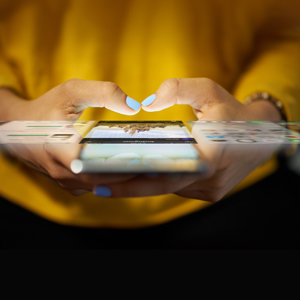 Woman typing onto a mobile device screen.