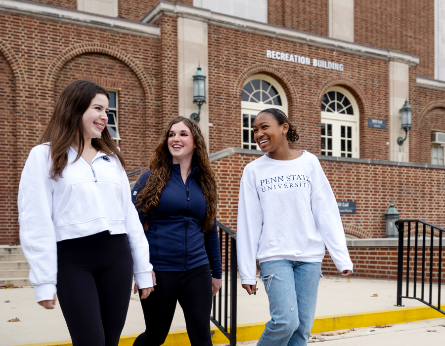 three female students walking outside rec hall 