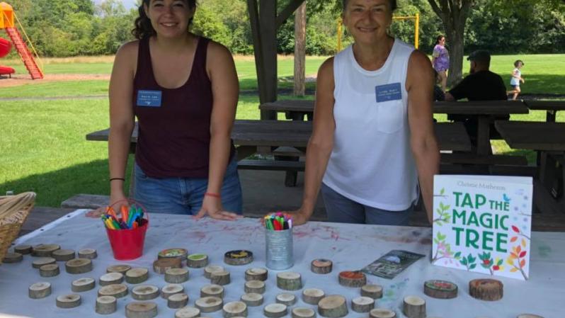 Volunteers from the Children's Garden at the Arboretum at Penn State standing with the tree cookies they brought for kids to decorate.