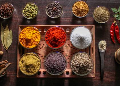 An array of brightly colored spices laid out on a table