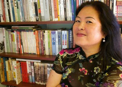 Picture of Duke University professor Eileen Cheng-yin Chow in front of a bookshelf