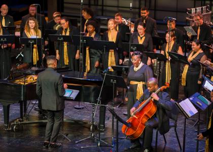 A diverse choir performs on a stage.