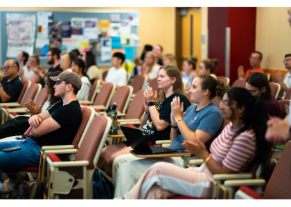 A group of second-year doctoral students clap after a presentation during the 2024-2025 neuroscience seminar series.