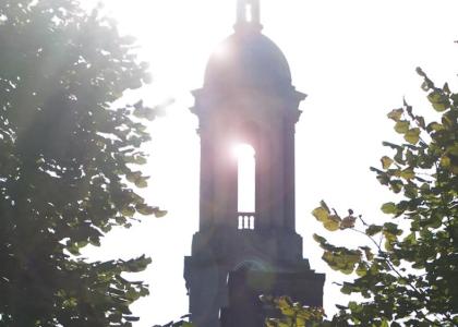 Sun streaming through Penn State's Old Main bell tower