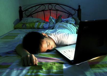 sleeping teen with laptop