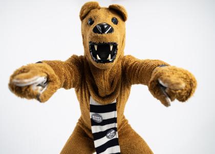 The Nittany Lion mascot points to the camera with both hands