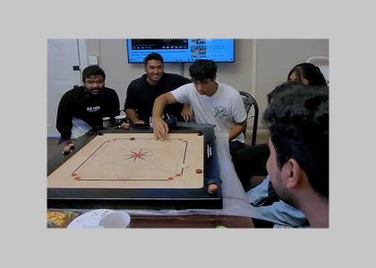 Penn State students playing a game of carrom