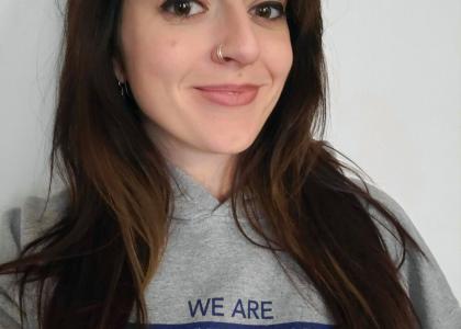 A photo of a woman wearing a Penn State sweatshirt.