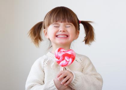 girl with heart-shaped lollipop