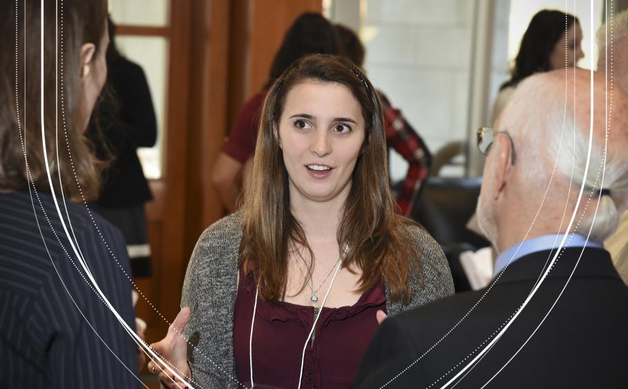 Student talking with Faculty and Alumni. 