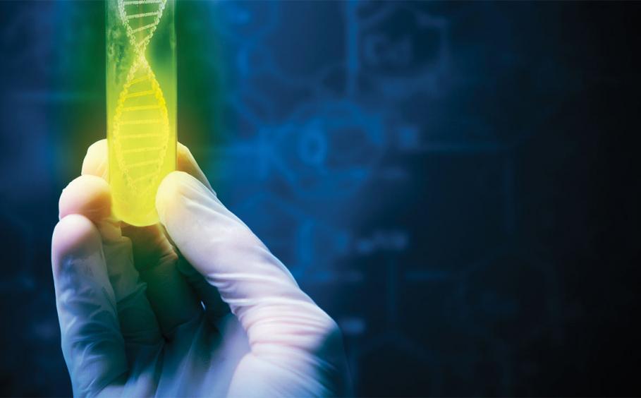 A gloved hand holding a green and yellow test tube with a DNA graphic inside on a dark background.