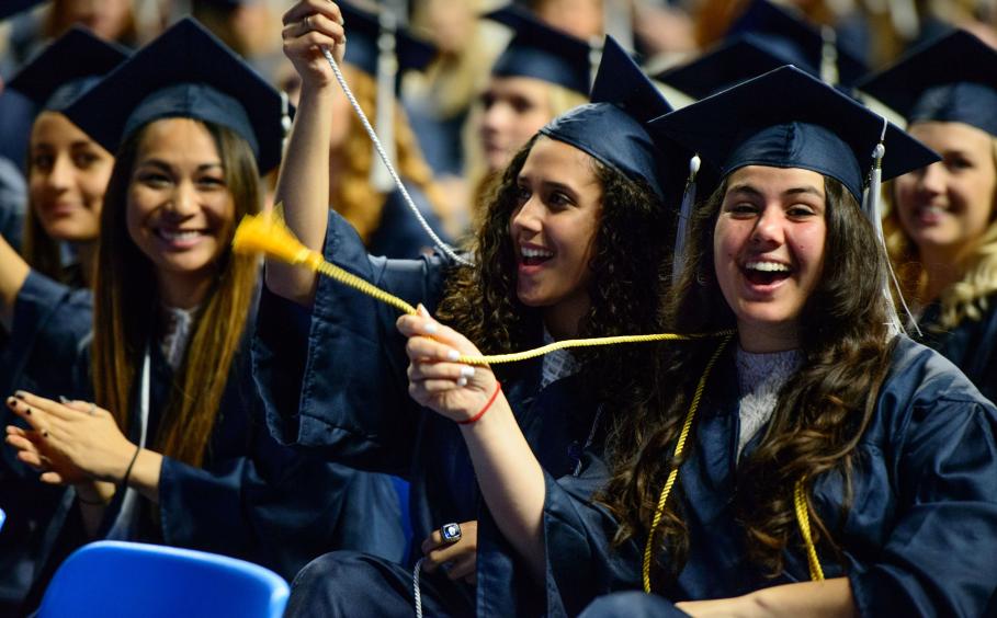 students sitting at Penn State graduation
