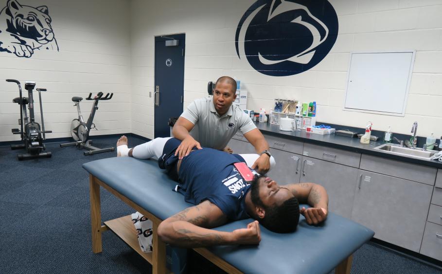 Athletic trainer working on an athlete. 