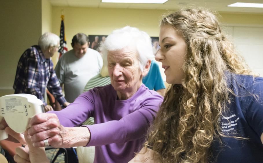 A student working with a residence at the Village at Penn State.