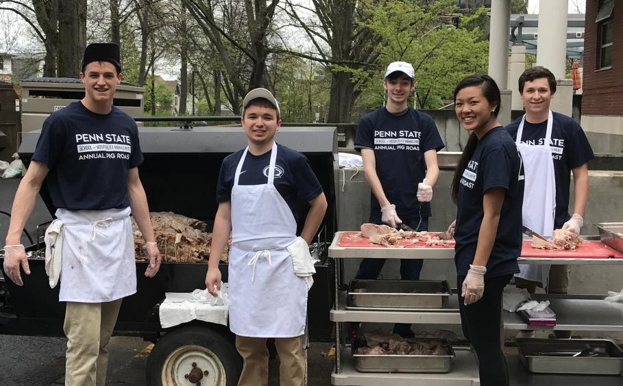 Students working at the annual pig roast.