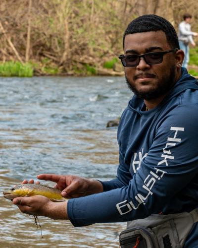 Fly Fishing student holding fish