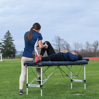 Student athletic trainer working with a student athlete. 