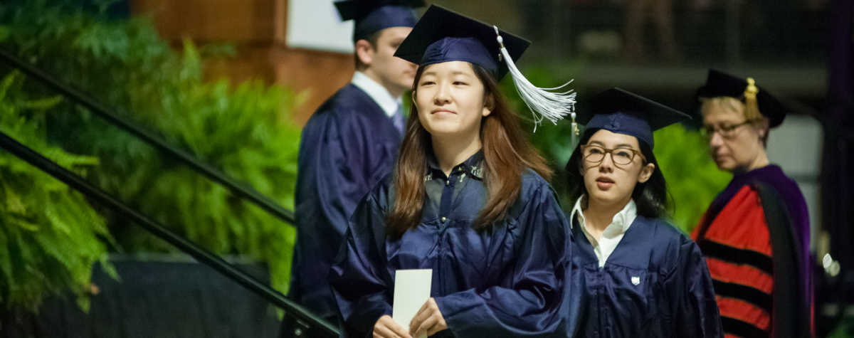 student walking at commencement 