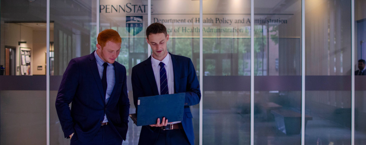 Two male students working on a laptop