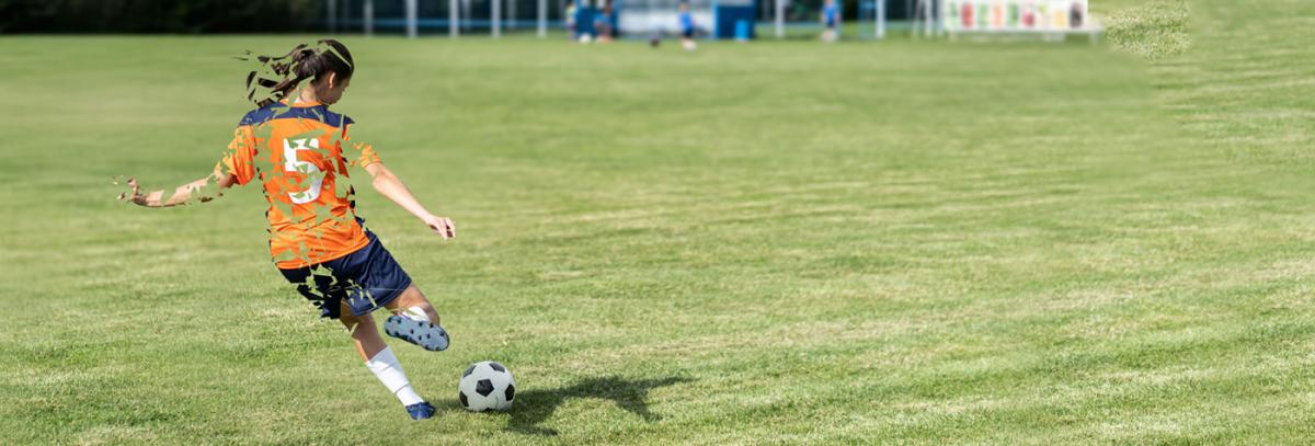 A girl goes to kick a soccer ball, but her image is fragmented. 