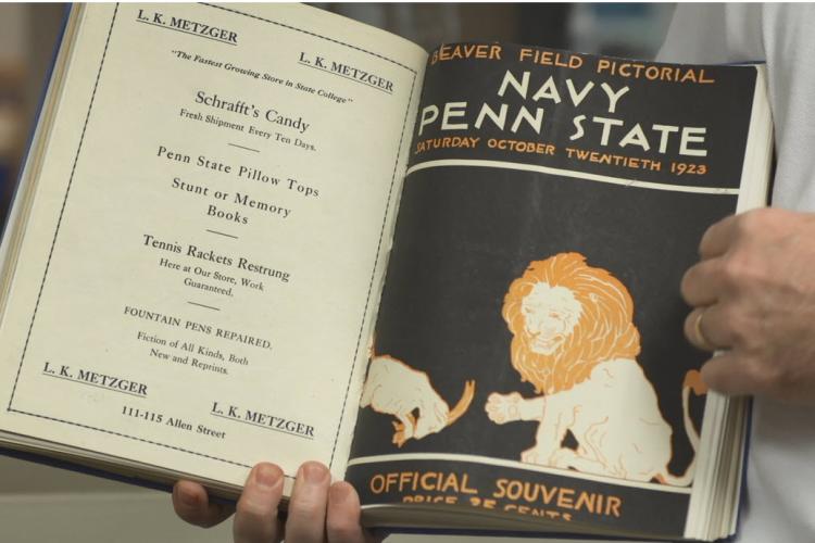 book held open to show old Penn State sports programs