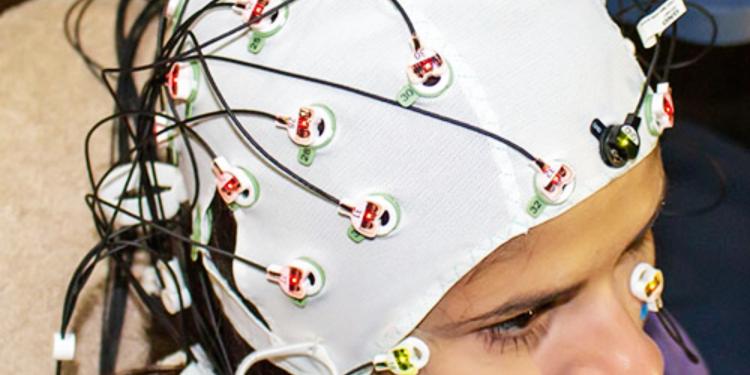 research participant wears a cap to monitor brain waves