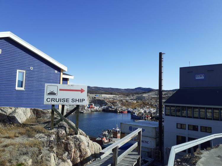 Village in Greenland with a cruise ship sign