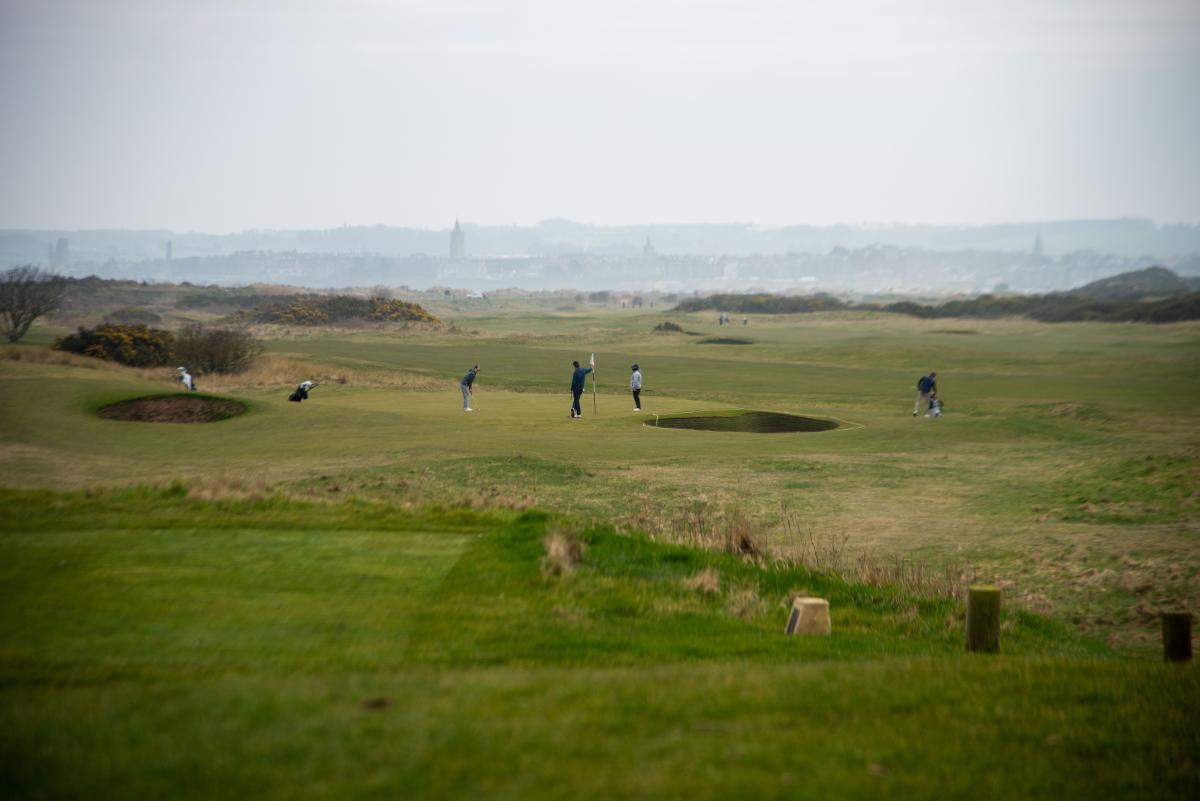 =Golfers on a golf course in St Andrews, Scotland