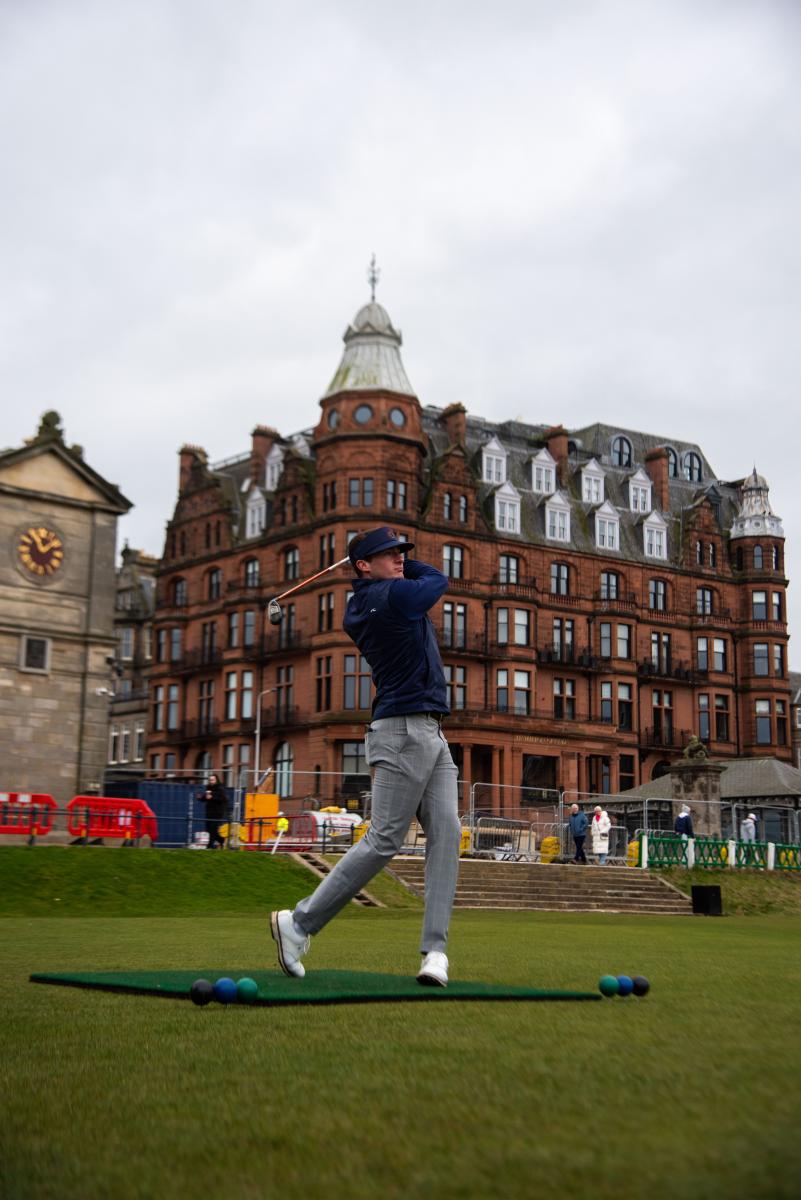 =Sam swings a golf club on the 1st tee box at The Old Course